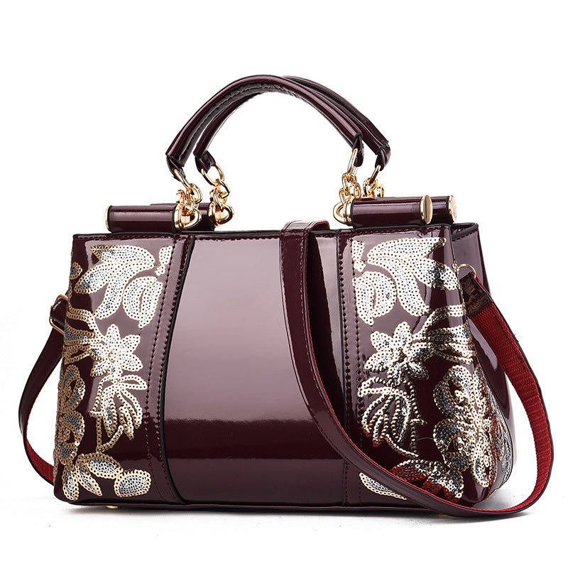 Sequin embroidered patent evening handbag