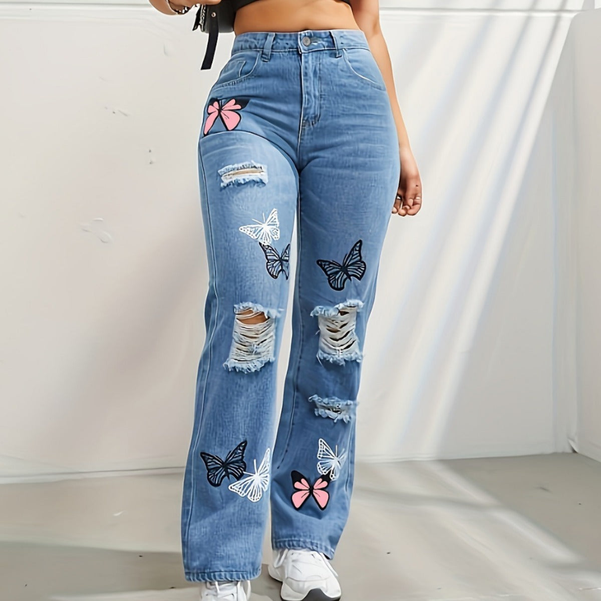 High-waisted straight leg jeans with butterfly print and rips