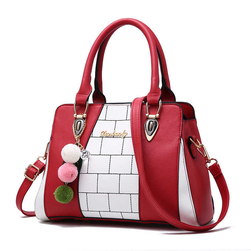Two-tone handbag with pompom charm