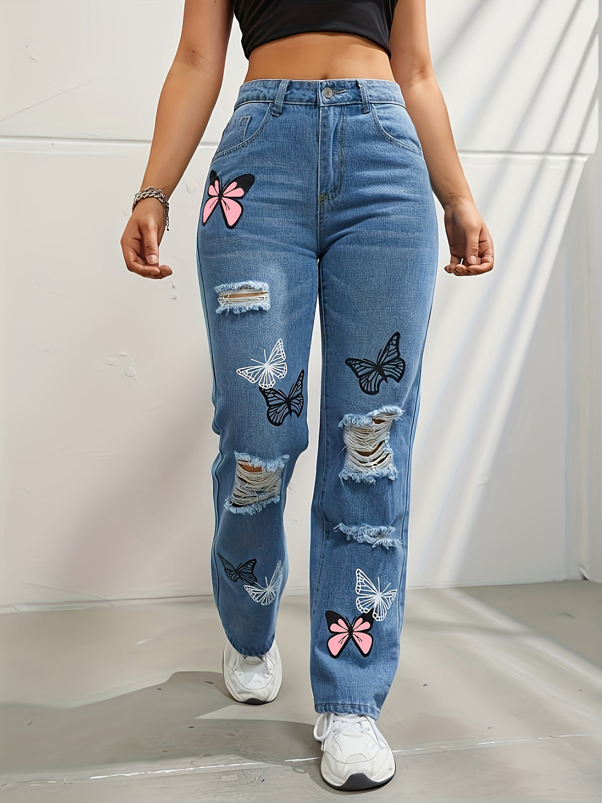 High-waisted straight leg jeans with butterfly print and rips