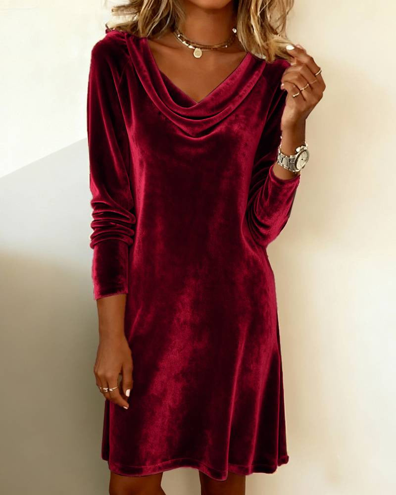 Woman in a velvet cowl-neck mini dress