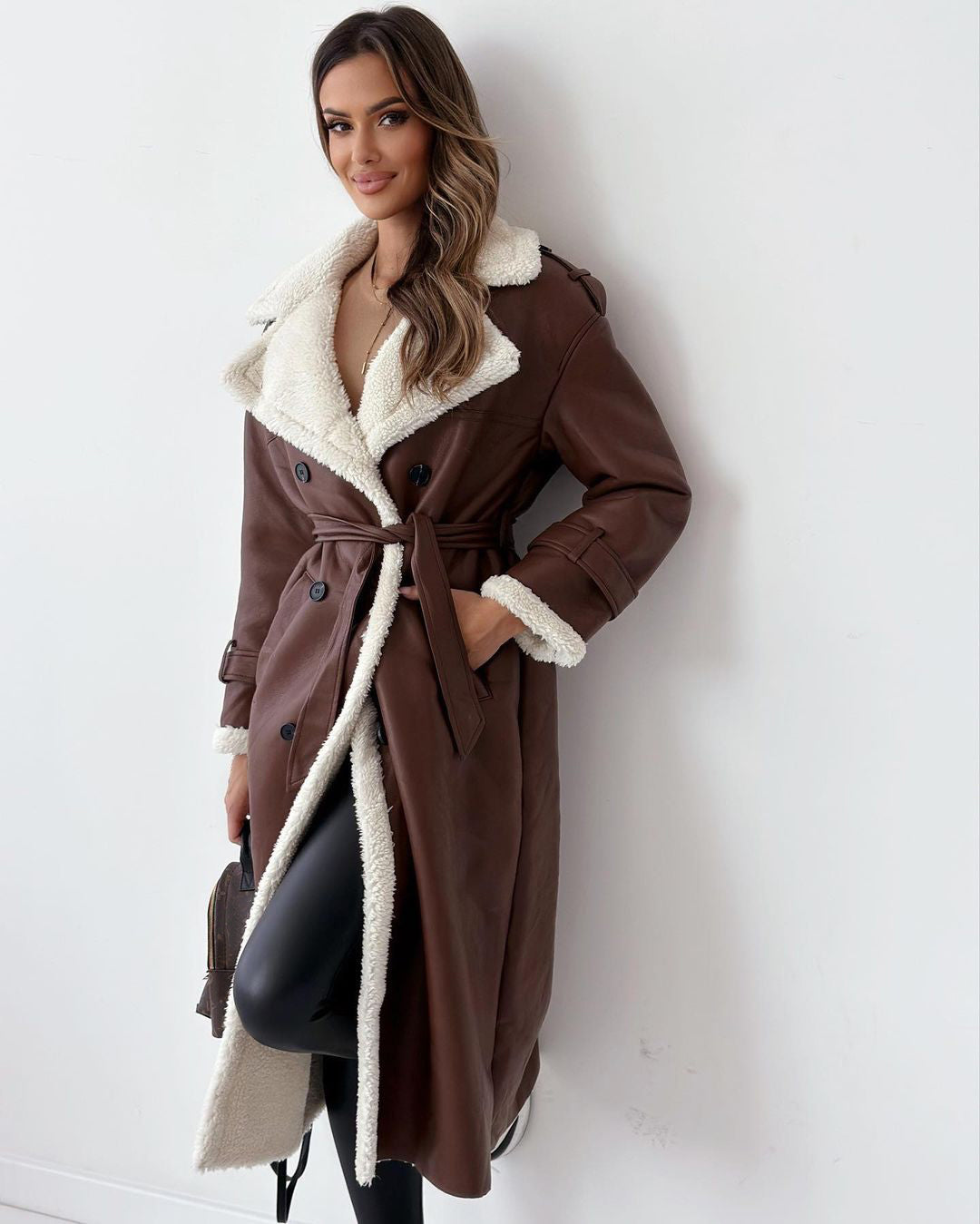 Woman in a long double-breasted belted coat